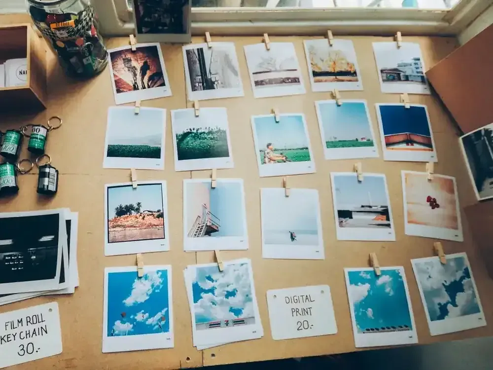 Mesa de trabajo con fotografías impresas montando un moodboard